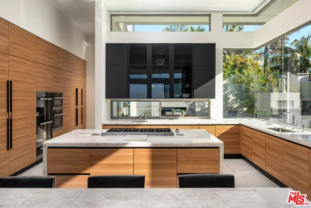 a large kitchen with stainless steel appliances granite countertop a stove and a sink