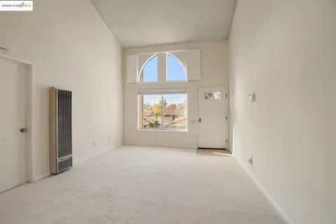 an empty room with windows and closet