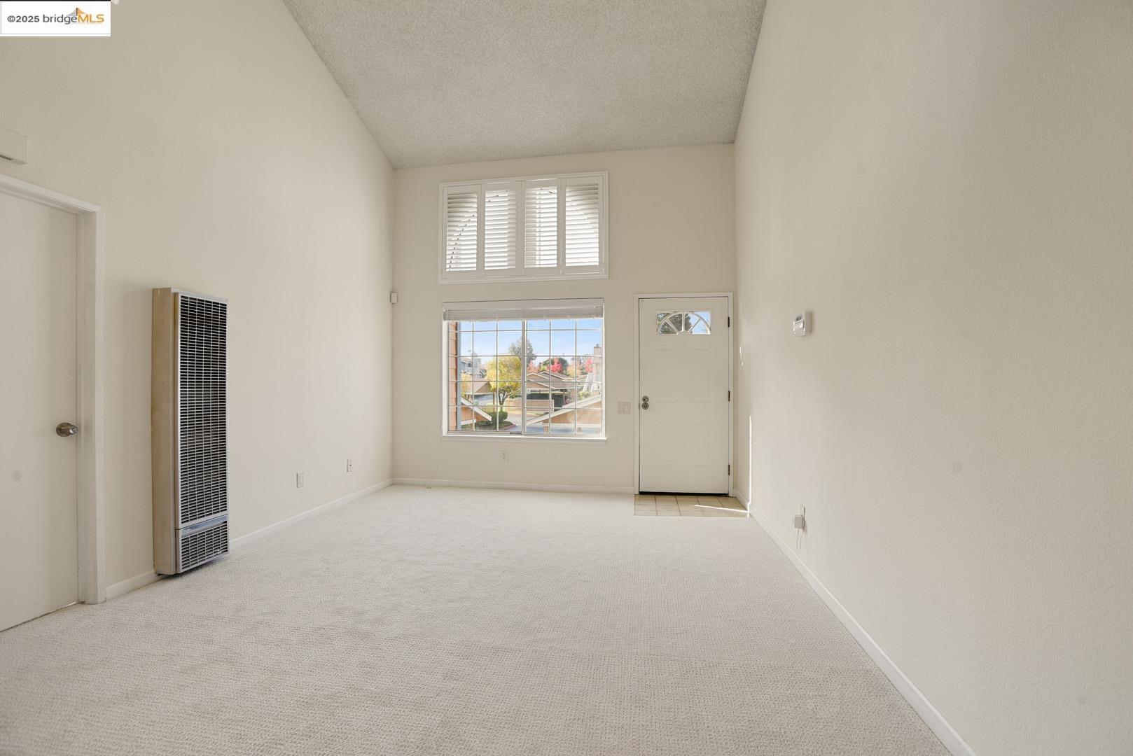 44 Glenwood Hercules, CA 94547 - Photo 7 of 35 an empty room with windows and mirror