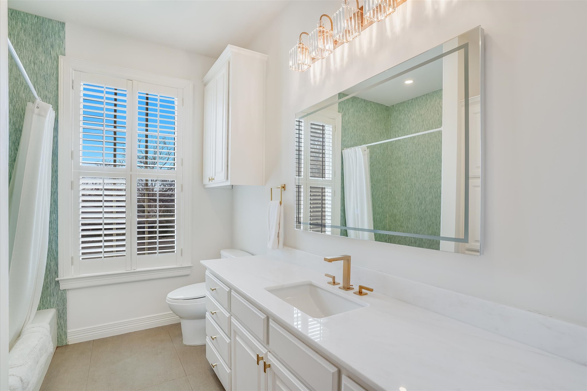 3705 Gilbert Street, Unit B Austin, TX 78703 - Photo 20 of 35 Bathroom with vanity, baseboards, an inviting chandelier, tile patterned flooring, and toilet