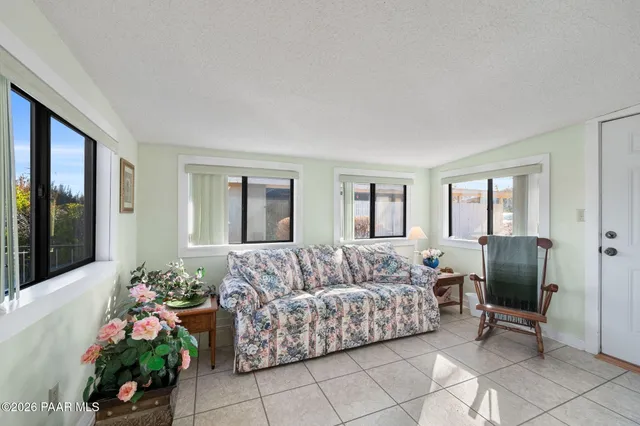 a living room with furniture potted plant and a window