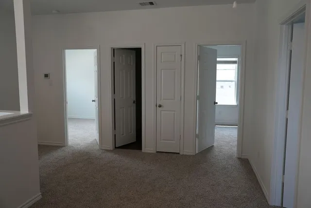 a view of a hallway with closet area
