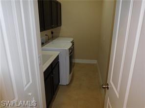 6853 Il Regalo Circle Naples, FL 34109 - Photo 11 of 13 a bathroom with a sink and washing machine