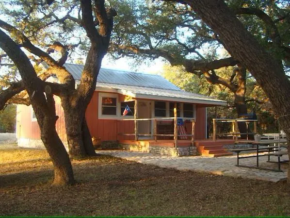 a front view of a house with a yard chairs and table