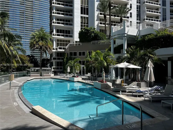 a view of a swimming pool with sitting area