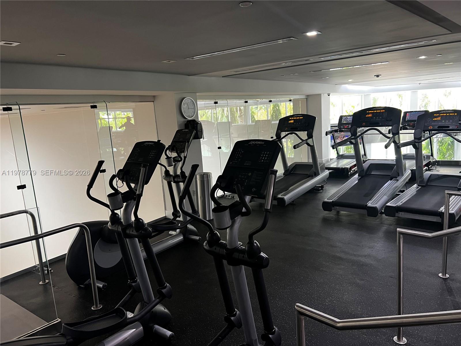 901 Brickell Key Boulevard, Unit 1001 Miami, FL 33131 - Photo 15 of 18 a view of a room with gym equipment
