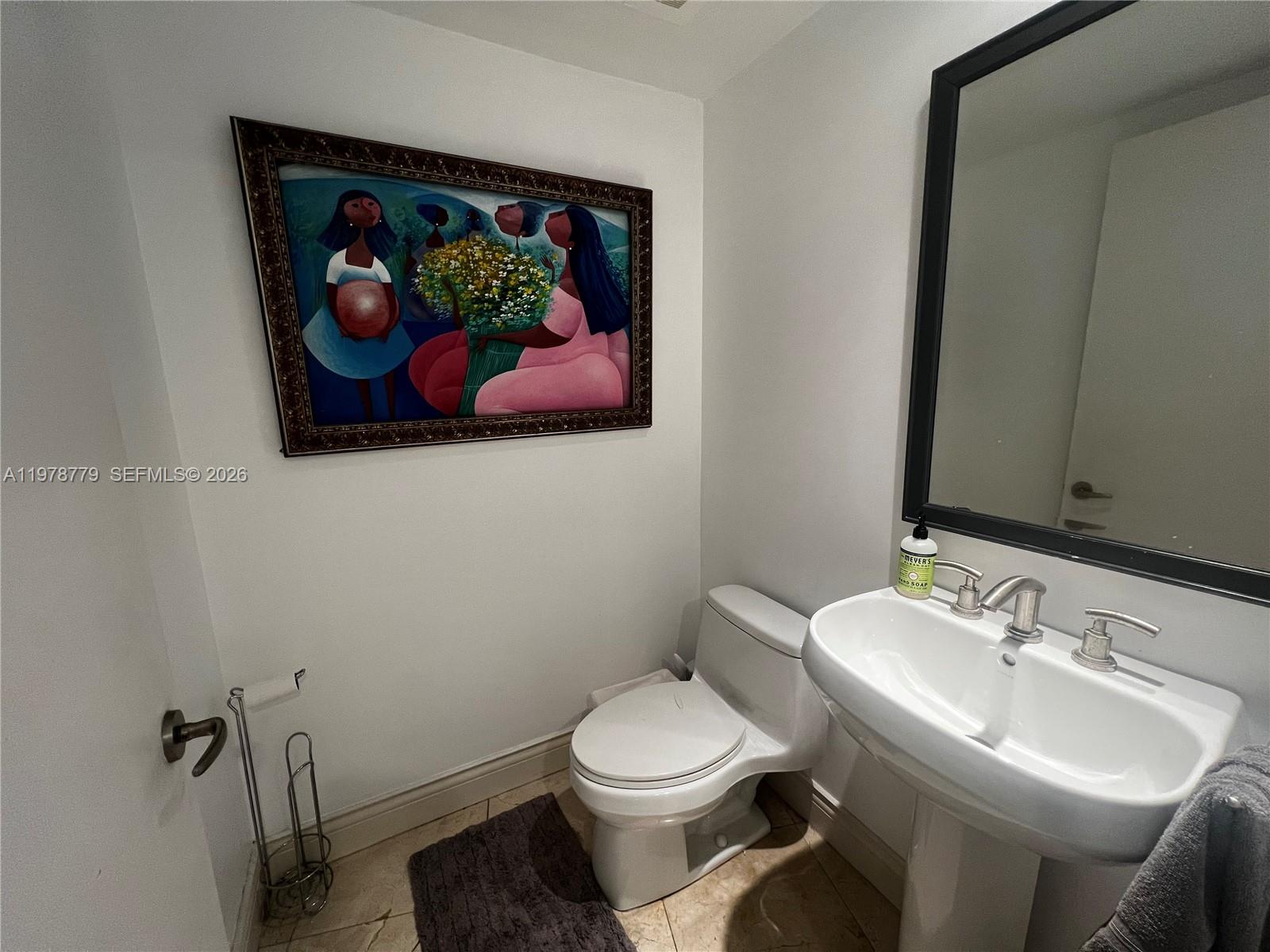 901 Brickell Key Boulevard, Unit 1001 Miami, FL 33131 - Photo 3 of 18 a bathroom with a toilet a sink and view kitchen