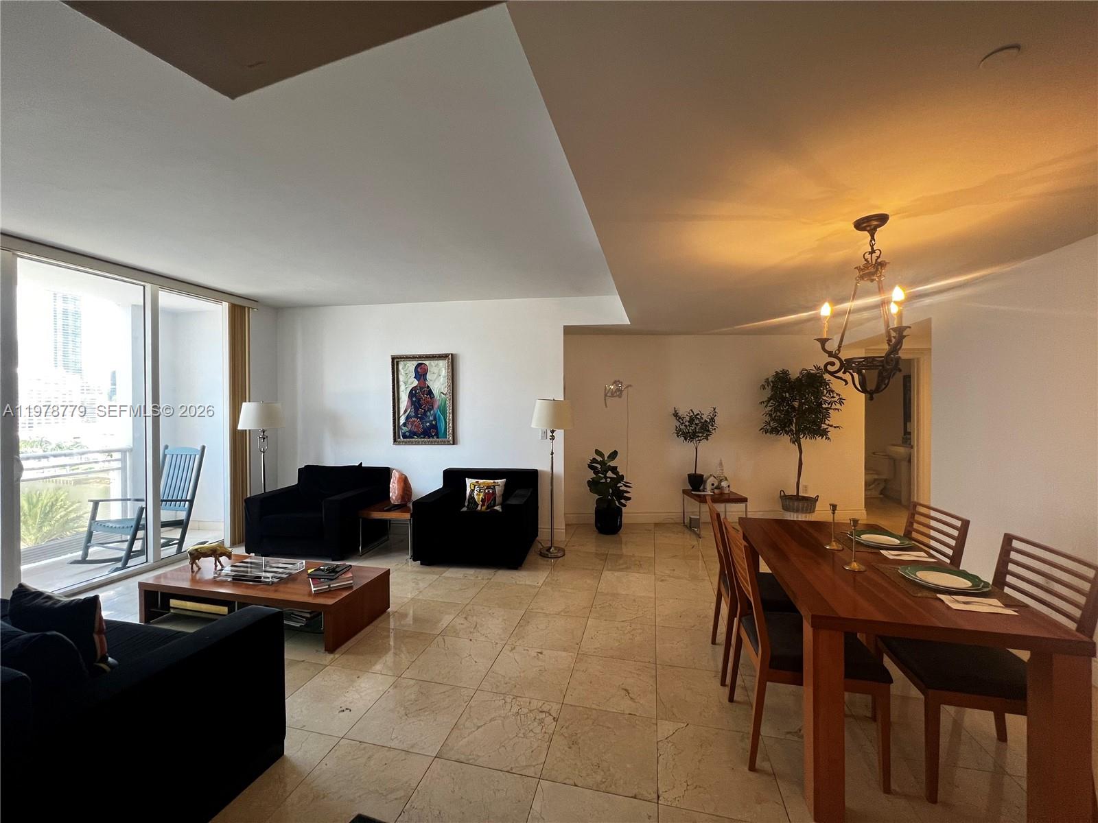 901 Brickell Key Boulevard, Unit 1001 Miami, FL 33131 - Photo 4 of 18 a view of a livingroom with furniture and window