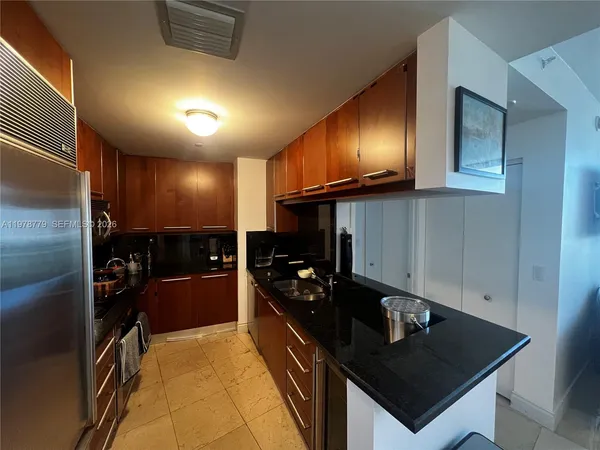 a kitchen with refrigerator and cabinets
