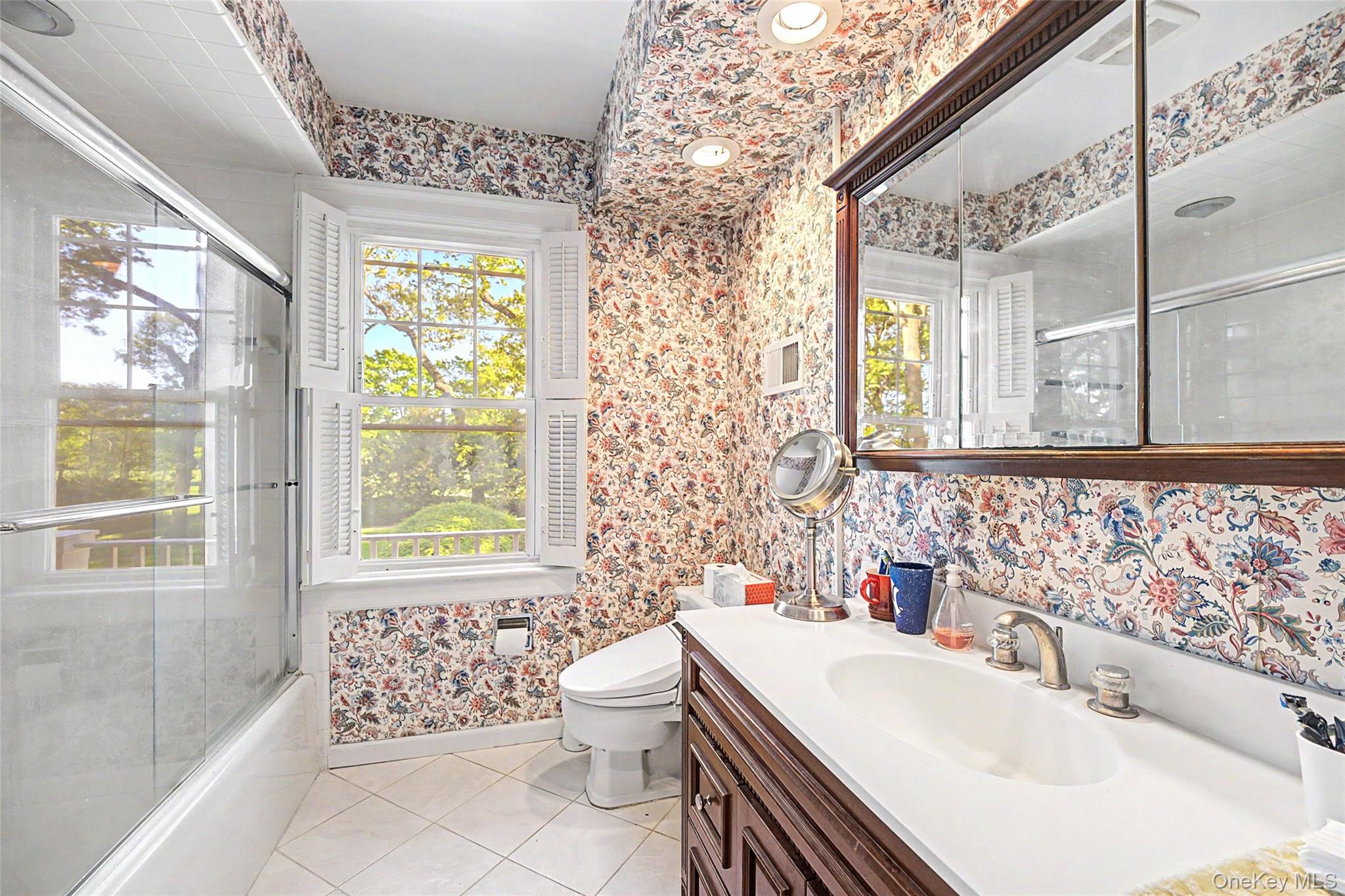 23 Townsend Road Glen Cove, NY 11542 - Photo 17 of 23 a bathroom with a sink toilet a mirror and next to a window