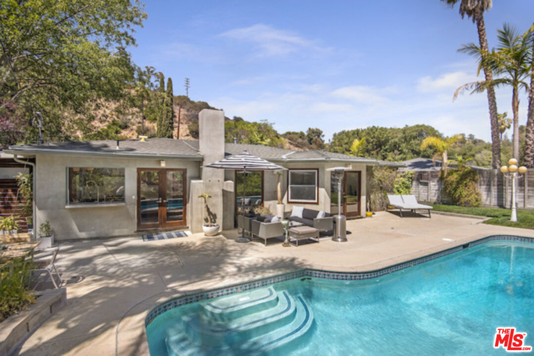a view of a house with sitting area and garden