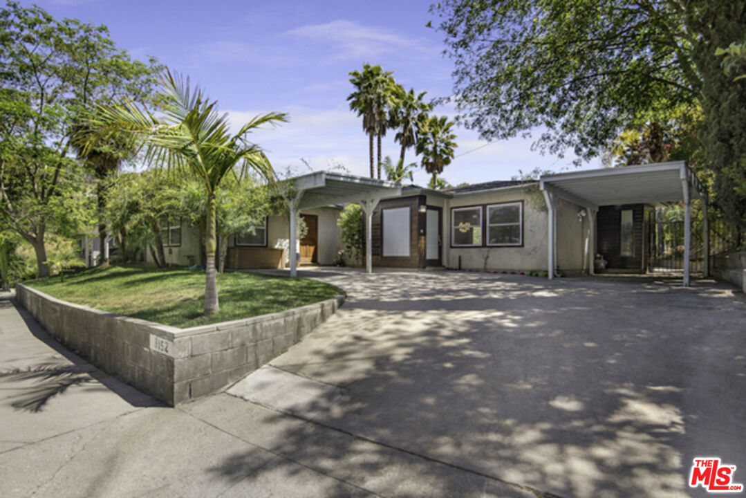8152 Amor Road Los Angeles, CA 90046 - Photo 2 of 27 a front view of a house with a garden and trees