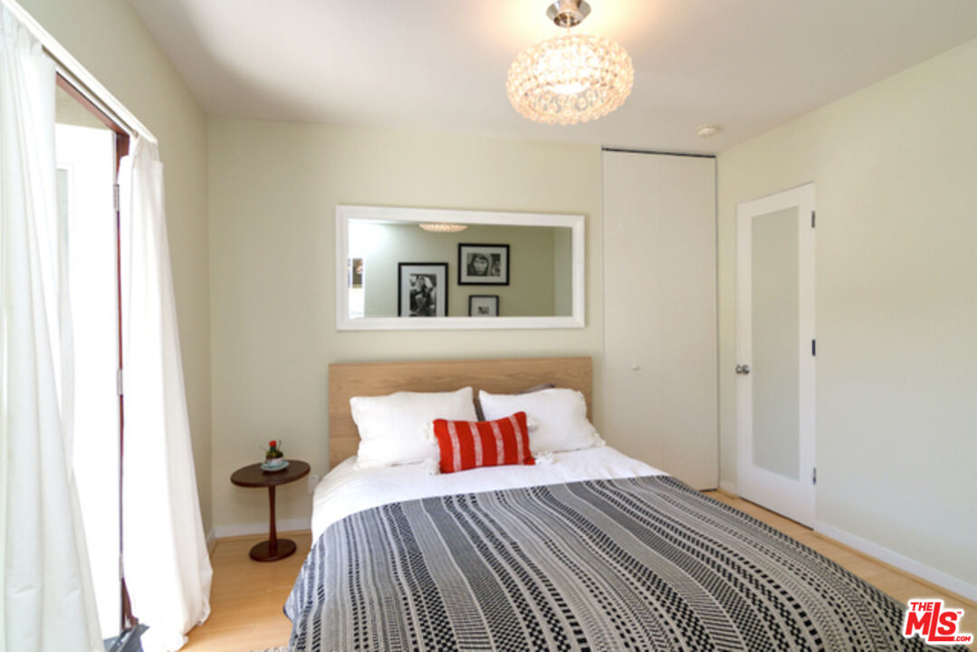 8152 Amor Road Los Angeles, CA 90046 - Photo 15 of 27 a bedroom with a bed and wooden floor