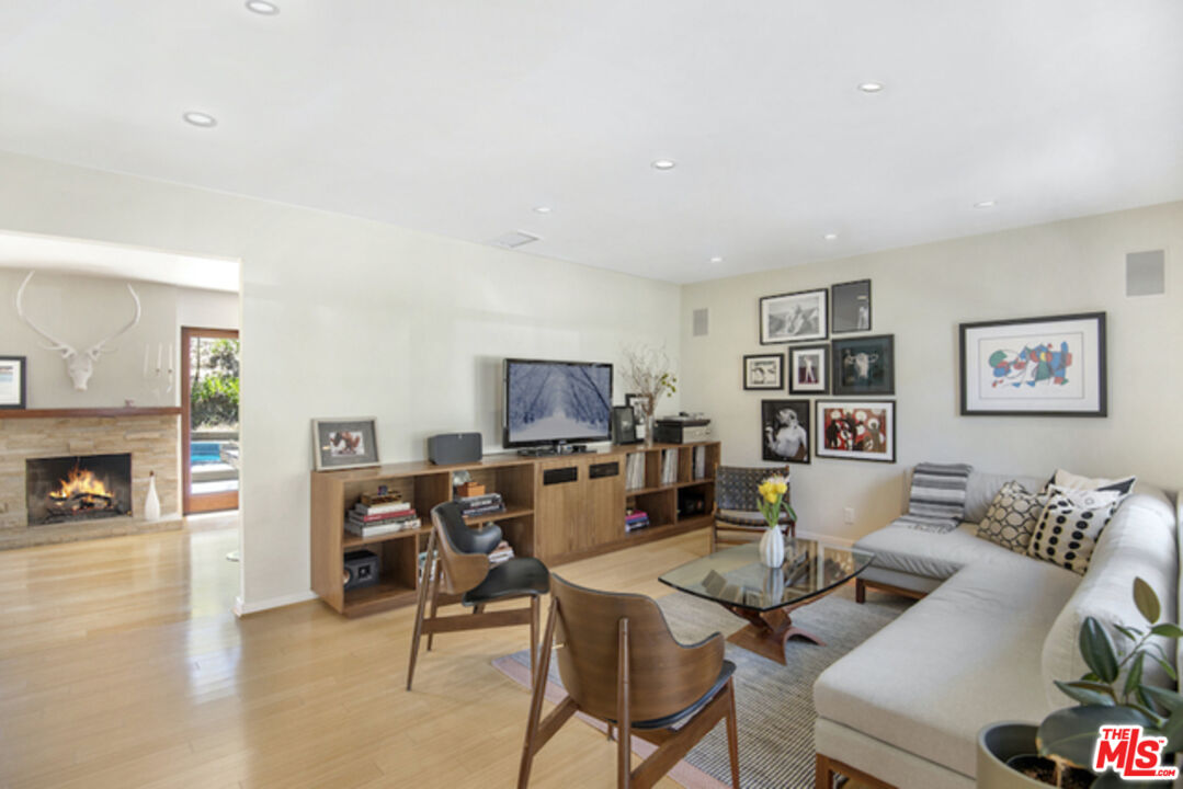8152 Amor Road Los Angeles, CA 90046 - Photo 3 of 27 a living room with furniture a flat screen tv and a fireplace