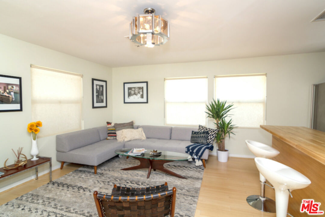 8152 Amor Road Los Angeles, CA 90046 - Photo 21 of 27 a living room with furniture and a chandelier