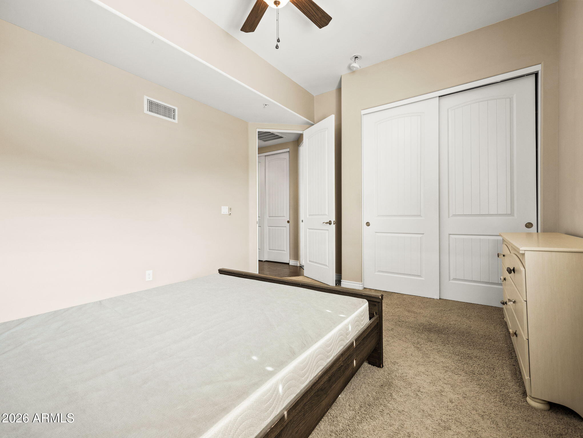 36600 North Cave Creek Road, Unit B14 Cave Creek, AZ 85331 - Photo 19 of 29 a spacious bedroom with a bed and a chandelier