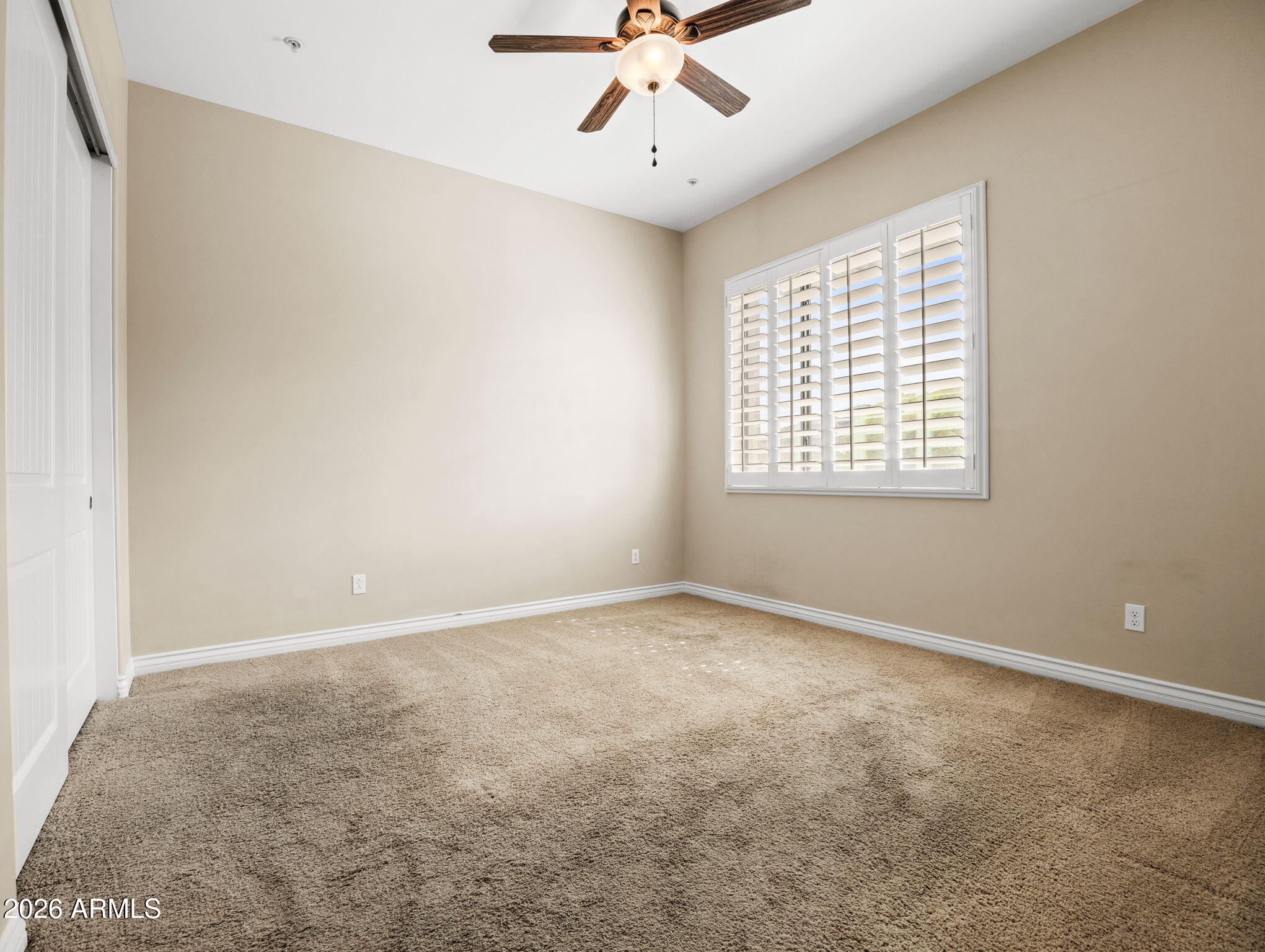 36600 North Cave Creek Road, Unit B14 Cave Creek, AZ 85331 - Photo 21 of 29 an empty room with chandelier fan and windows