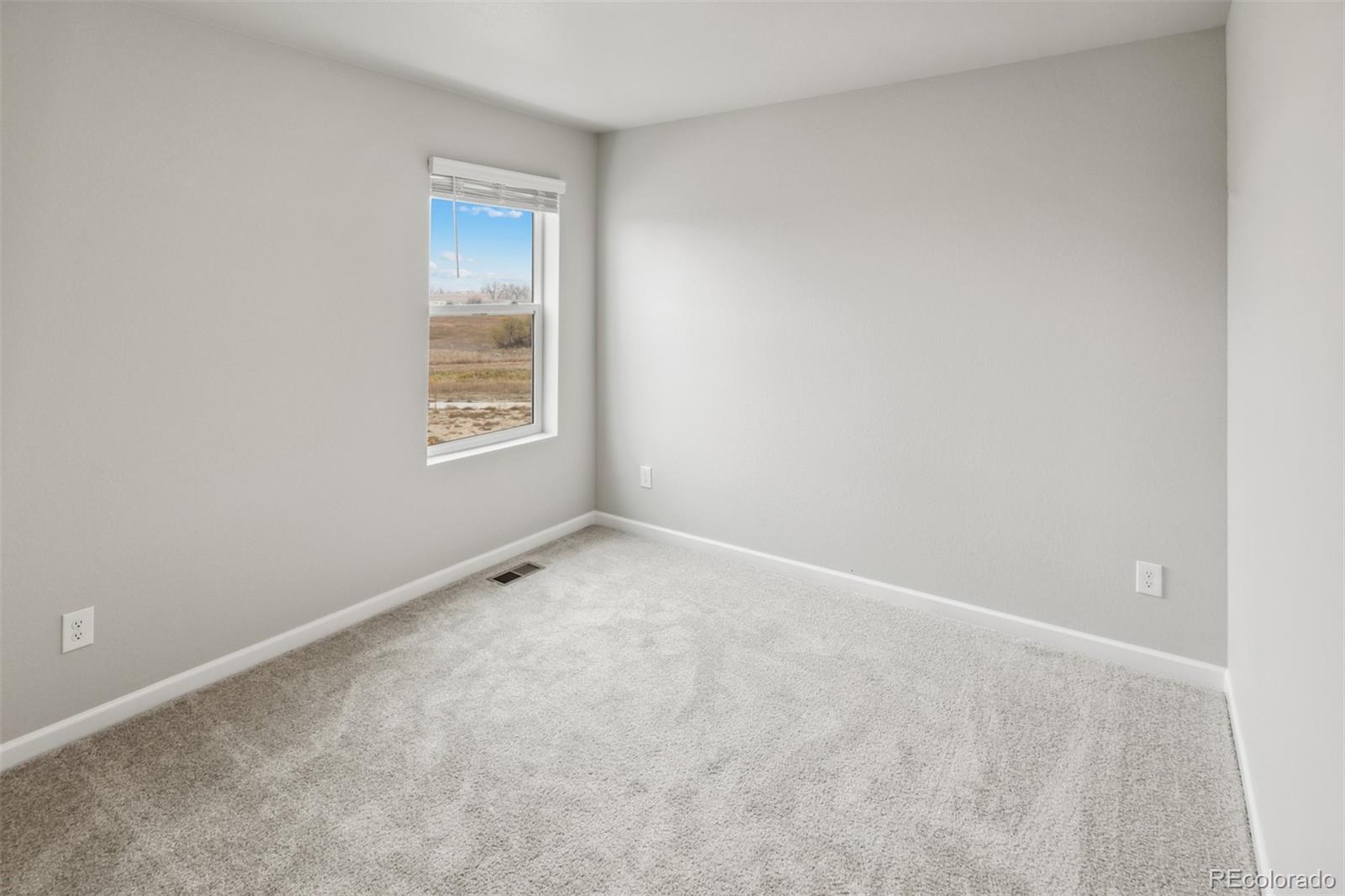 2175 Alyssa Street Fort Lupton, CO 80621 - Photo 15 of 39 a view of an empty room with a window