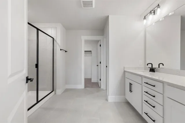 a bathroom with a double vanity sink and mirror