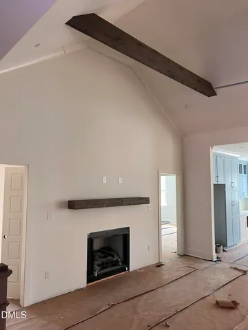 a view of an empty room with fire place and a fireplace