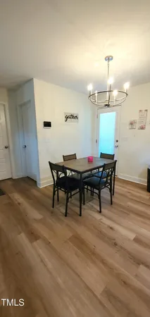 a view of a room with furniture and wooden floor