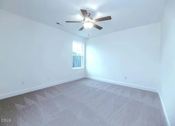 a bedroom with bed and window