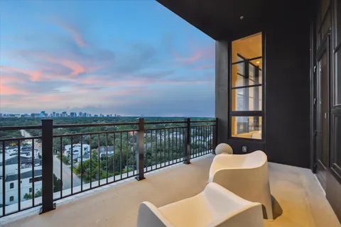 a balcony with table and chairs