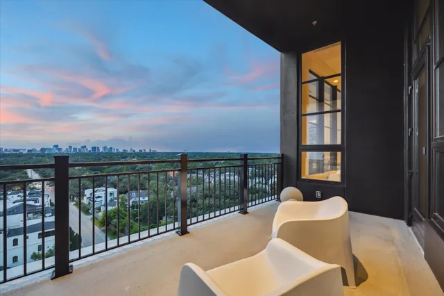 a balcony with table and chairs