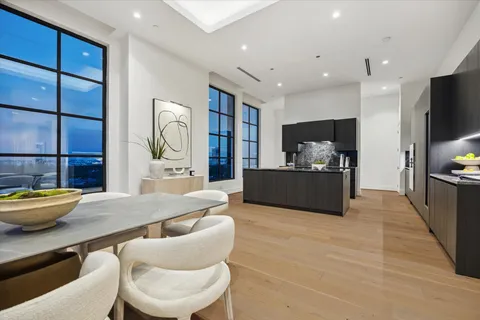 a kitchen with stainless steel appliances kitchen island granite countertop a table and chairs