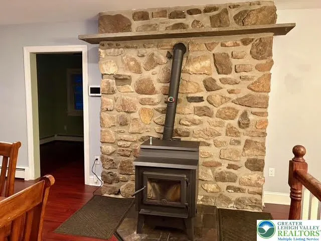 a living room with a fireplace and a wooden floor