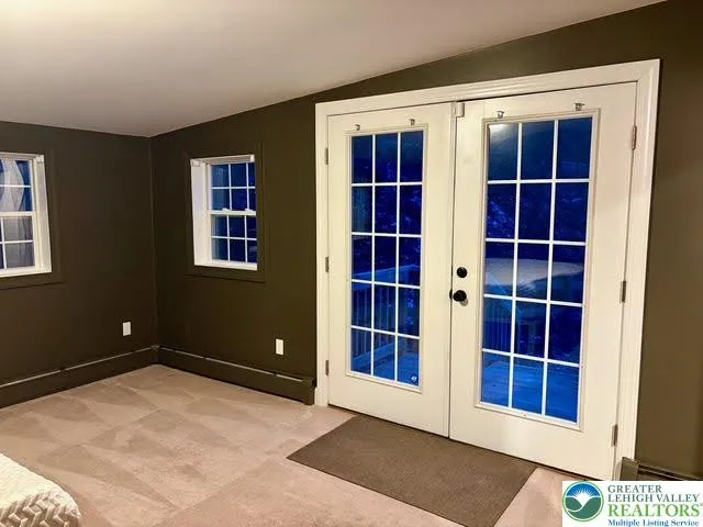 a view of empty room with windows and entryway