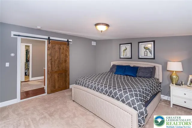 a bedroom with a large bed and a chandelier