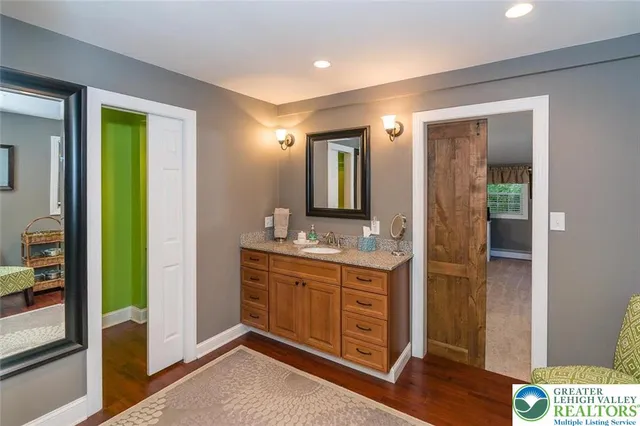 a bathroom with a double vanity sink and a mirror
