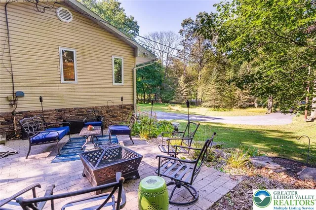 a view of a patio with couple of chairs and a table