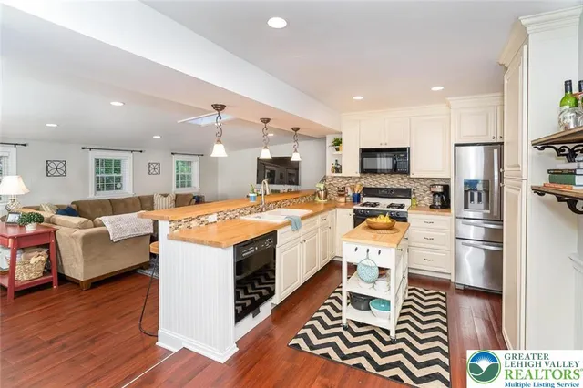 a kitchen with a sink appliances and cabinets