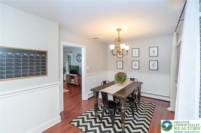 a dining room with furniture and chandelier