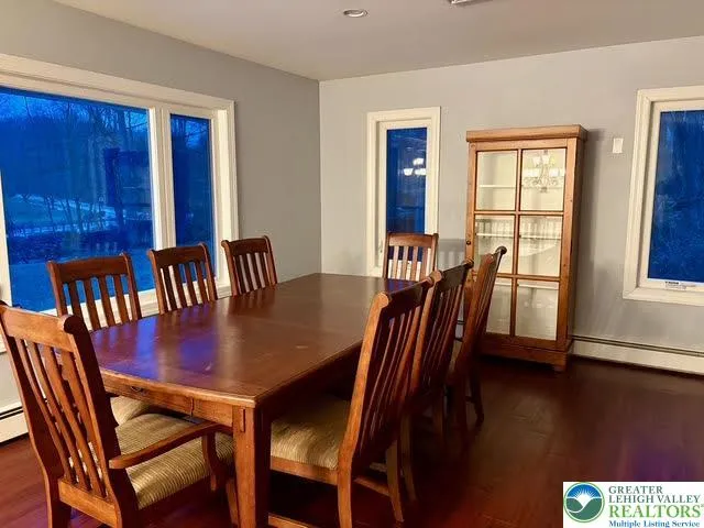 a view of a a dining room with furniture window and wooden floor