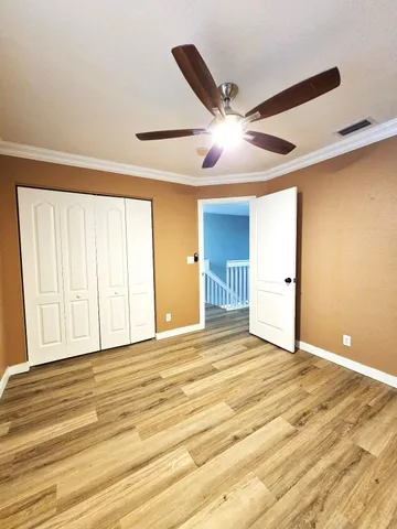 a view of walk in closet with empty racks