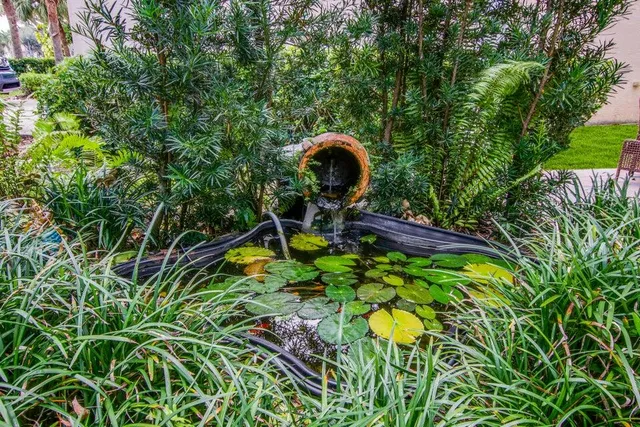 a view of backyard with table and chairs and wooden fence