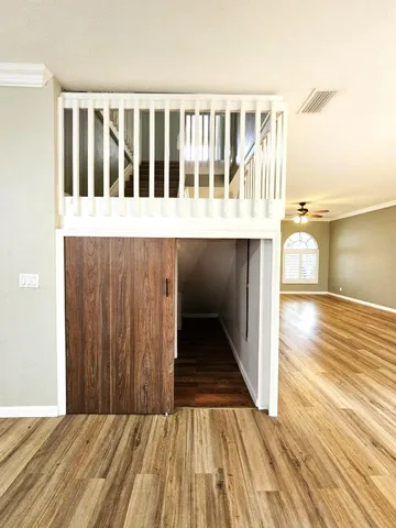 a view of a balcony with wooden floor