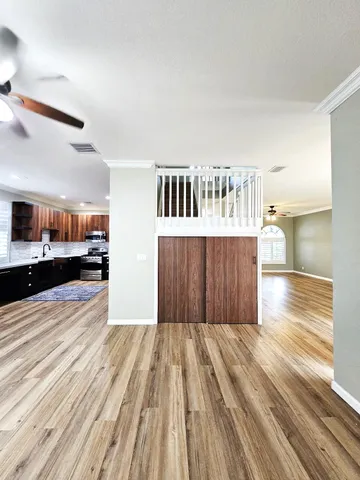 a kitchen with stainless steel appliances kitchen island granite countertop a refrigerator and a stove top oven