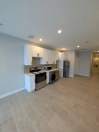 a view of a big room with a kitchen
