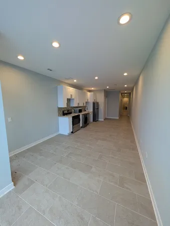 a kitchen with stainless steel appliances a refrigerator and a stove top oven