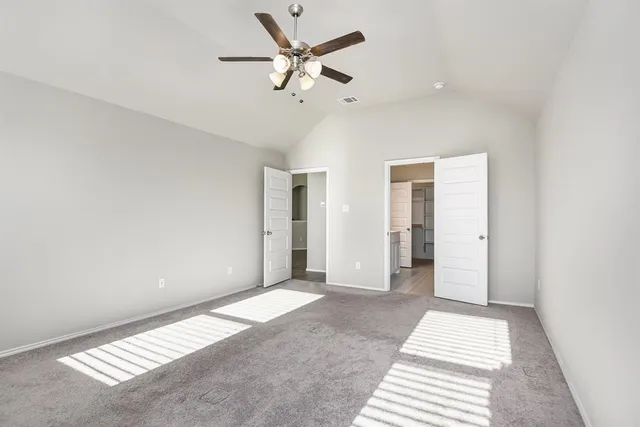 a view of a big room with closet and a ceiling fan