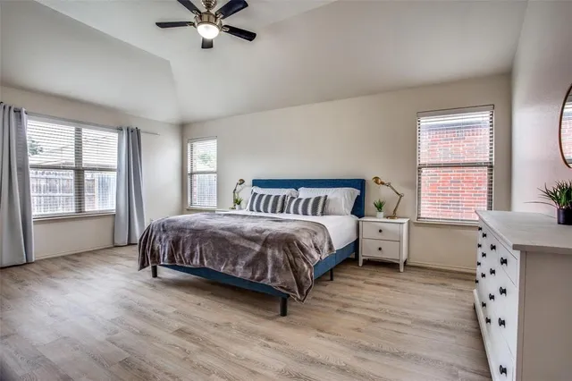 a spacious bedroom with a bed and window