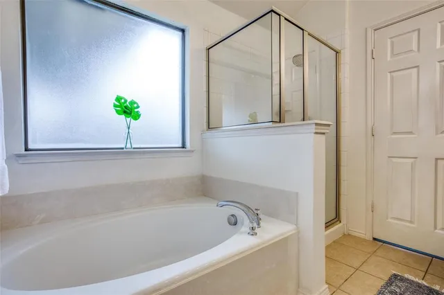 a bathroom with a tub and shower