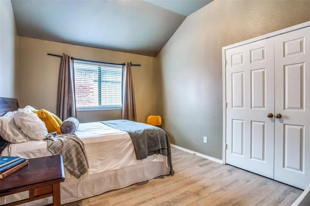 a bedroom with a bed and wooden floor