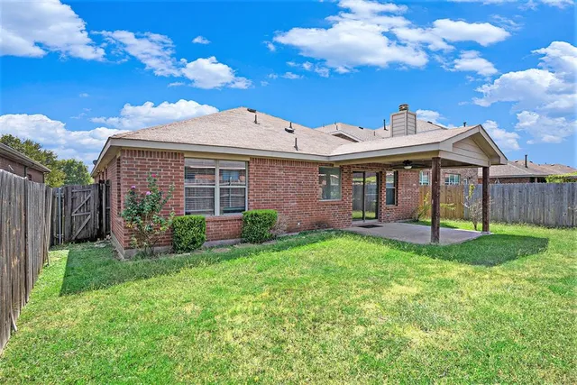 a front view of a house with yard porch and furniture