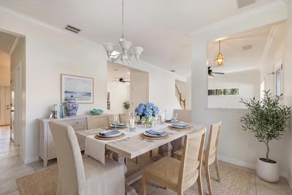 a view of a dining room with furniture and chandelier