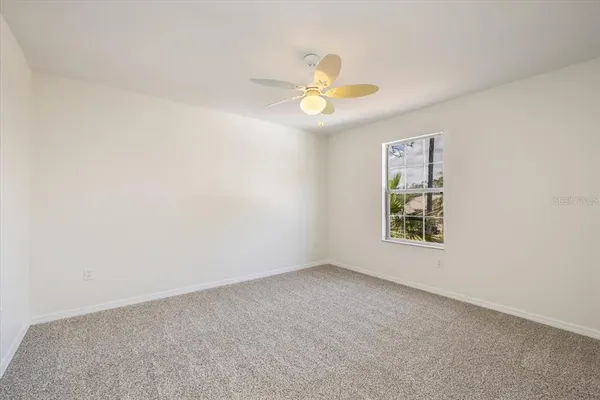 a view of a big room with wooden floor closet and windows